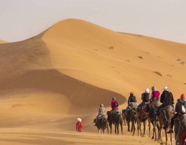 Arka planda güzel kumulları ile deve karavan Sahara tatlı olarak. Fas