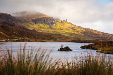 Loch Leathan and Old man of Storr rock formations, Isle of Skye, Scotland. Concept: typical Scottish landscape, tranquility and serenity, particular morphologie clipart