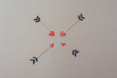 top view of four arrows on gray surface, valentines day concept clipart