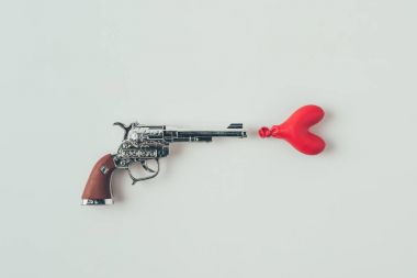beyaz, sevgililer günü kavramı izole kalp şeklinde balon hedefleyen silah üst görünümü