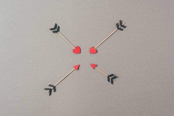 top view of four arrows on gray surface, valentines day concept