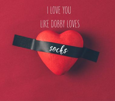 top view of red heart under insulating tape with words i love you like dobby loves socks on red clipart