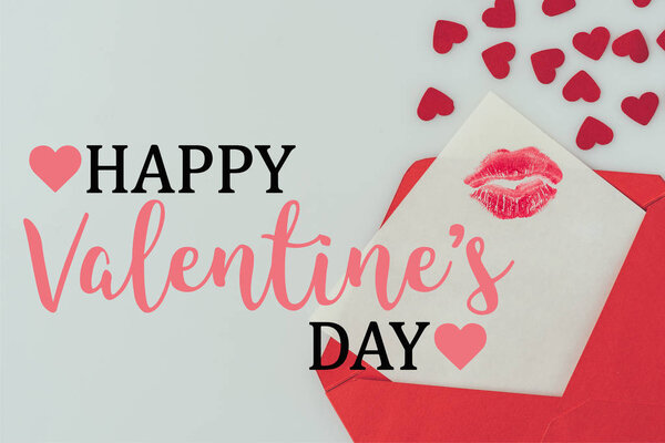 top view of happy valentines day postcard with lips print in envelope isolated on white
