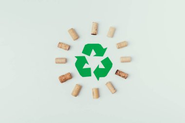 top view of recycle sign and bottle corks around isolated o grey clipart