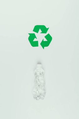 top view of recycle sign and plastic bottle isolated on grey clipart