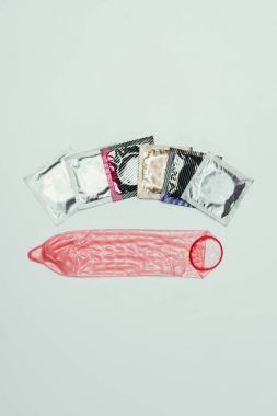 top view of arrangement of condoms isolated on grey, safety concept clipart