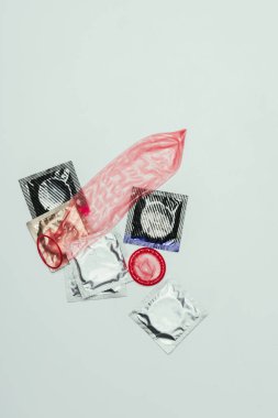 top view of arrangement of condoms isolated on grey, safety concept clipart