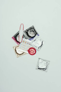 top view of pregnancy test and contraceptives isolated on grey clipart