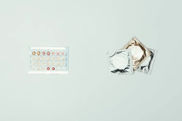 Vista Superior Preservativos Arranjados Pílulas Contraceptivas Isoladas Cinza — Fotografia de Stock