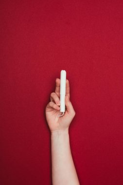 kırpılan görüntüsünü tutan kadın el üzerinde izole kırmızı tampon