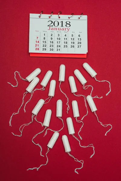 Tilikan Atas Tampon Menstruasi Dan Kalender Terisolasi Merah — Foto Stok Gratis