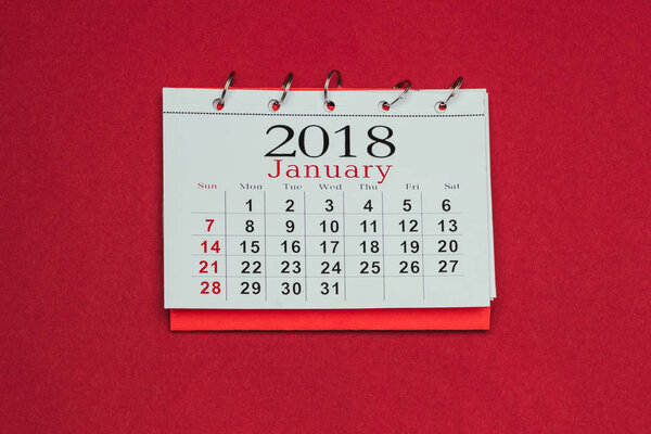 close up view of 2018 calendar isolated on red