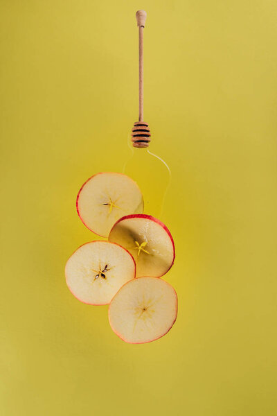 close up view of levitating pieces of apple and honey