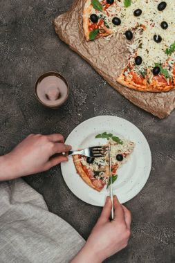 Bir dilim pizza koyu arka plan üzerinde kesme kadın görmek