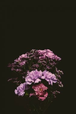 close-up view of beautiful floral bouquet of pink and purple blooming flowers isolated on black clipart