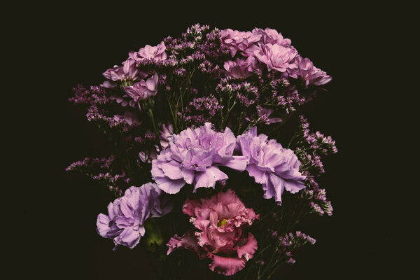 close-up view of beautiful tender pink and purple flowers isolated on black 