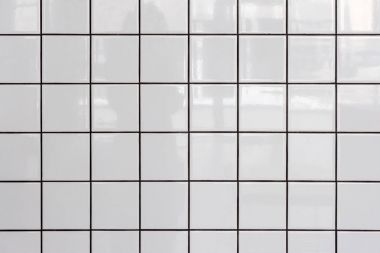 Wall of white glossy tiles with reflection clipart