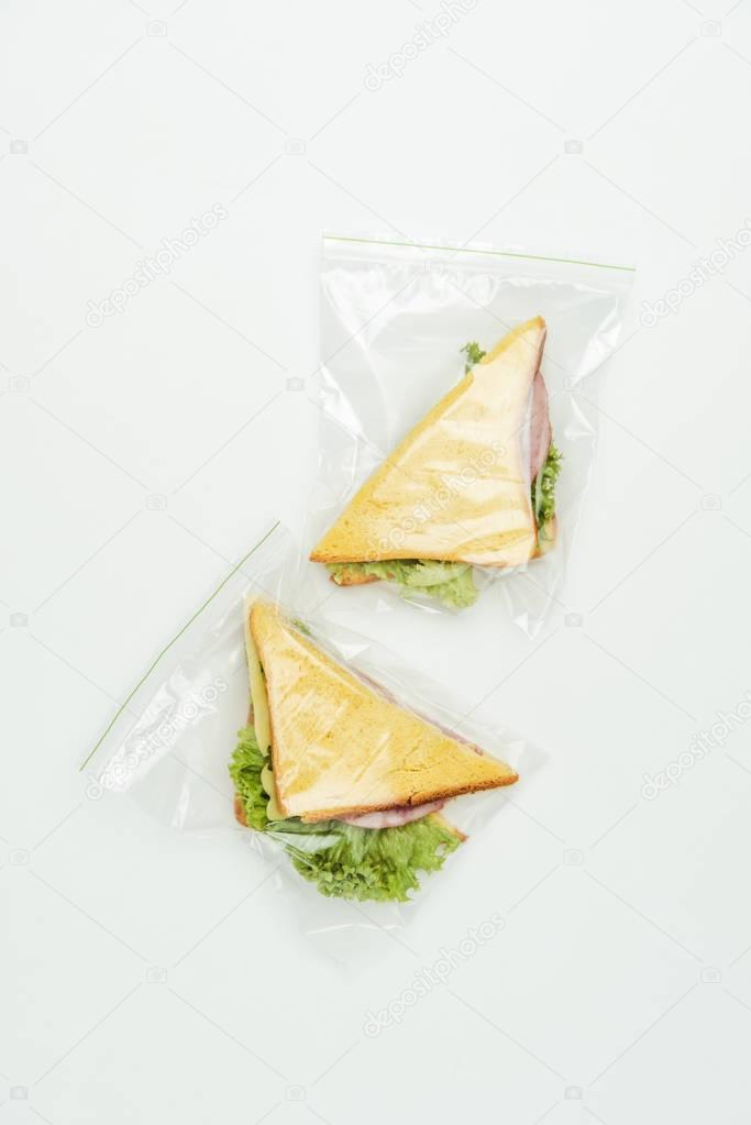 top view of two sandwiches in ziplock bags isolated on white