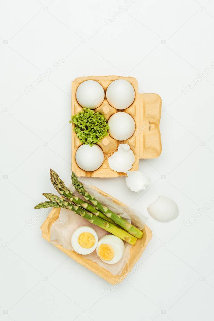 top view of eggs with tray and asparagus isolated on white