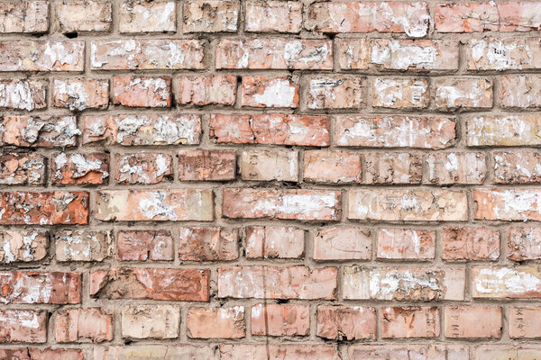 Old wall with broken bricks background
