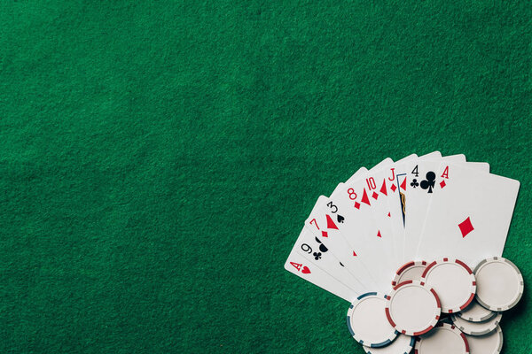 Gambling concept with cards and chips on casino table