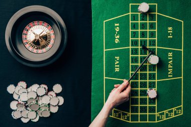 Woman moving chips on casino table with roulette clipart