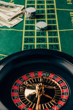 Casino table with roulette and placed chips clipart