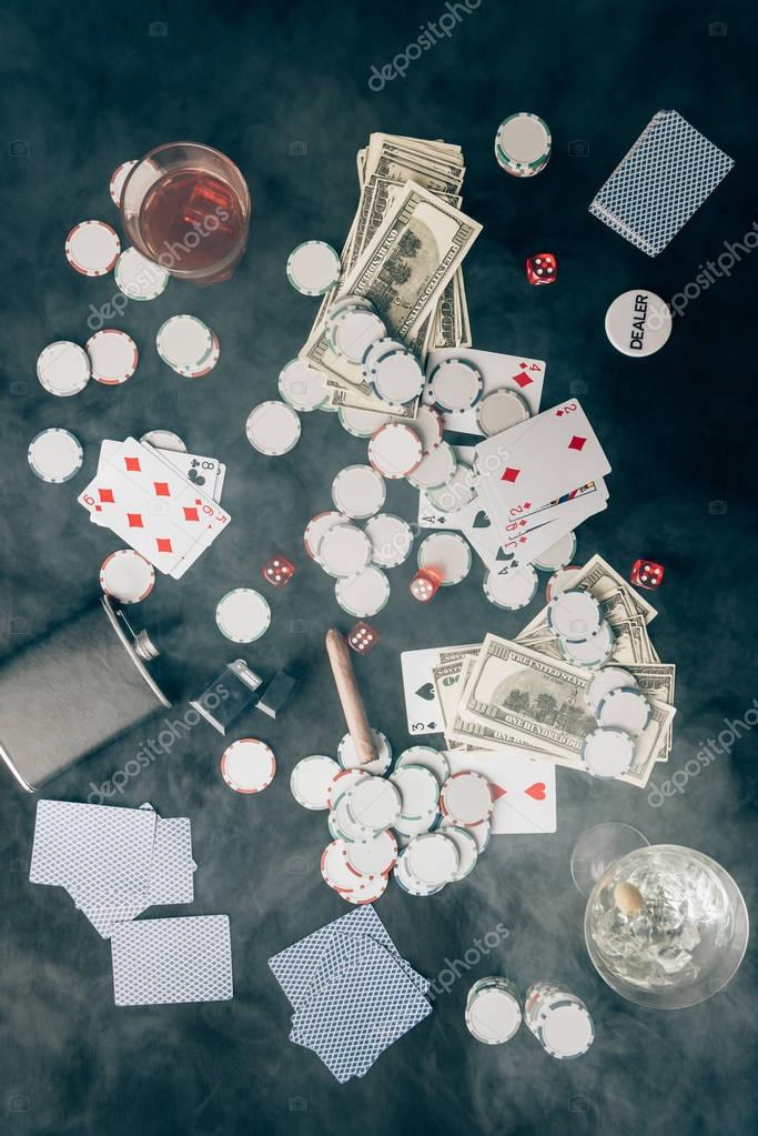Smoke over chips and money on casino table