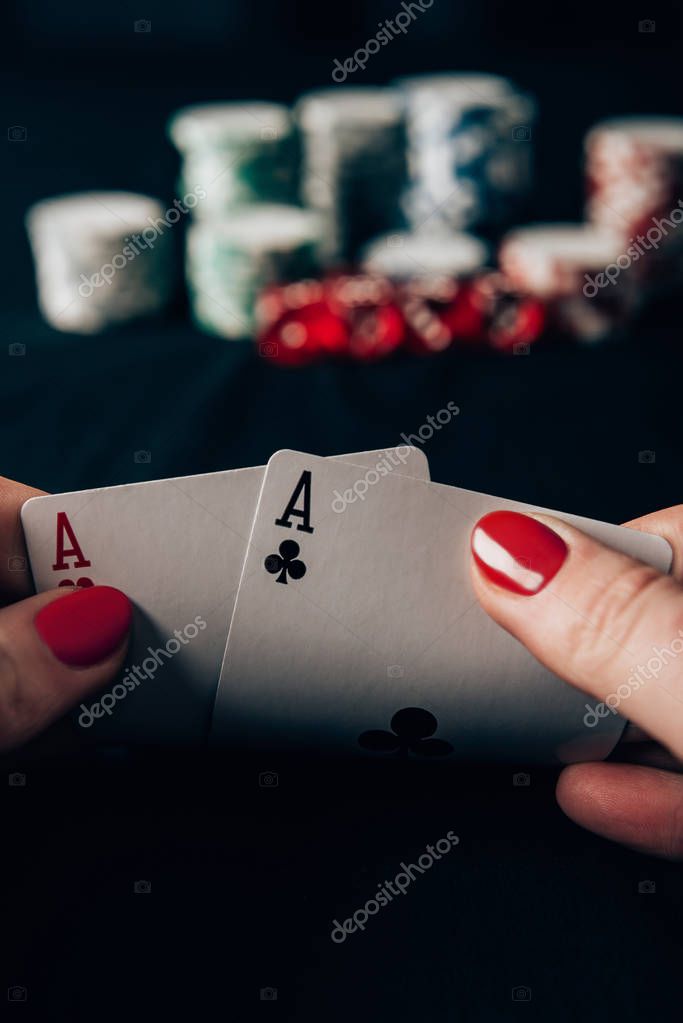 Woman playing poker game by casino table