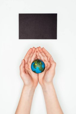 cropped image of woman holding earth model under blackboard isolated on white, earth day concept clipart