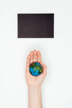 cropped image of woman holding earth model under blackboard isolated on white, earth day concept clipart