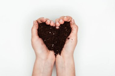 cropped image of woman holding heart shaped soil in hands isolated on white, earth day concept clipart