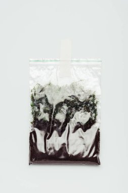 plastic bag with soil hanging isolated on white, earth day concept clipart