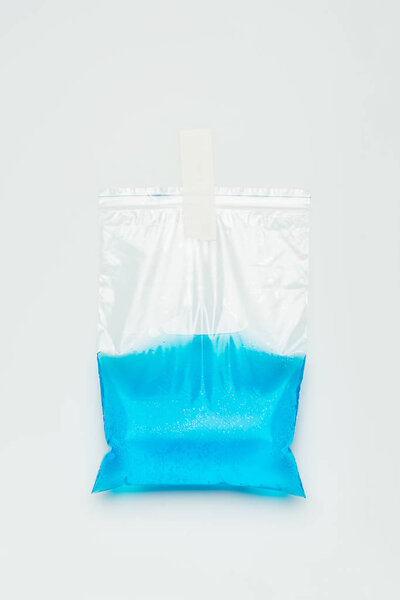 plastic bag with blue water hanging isolated on white, earth day concept