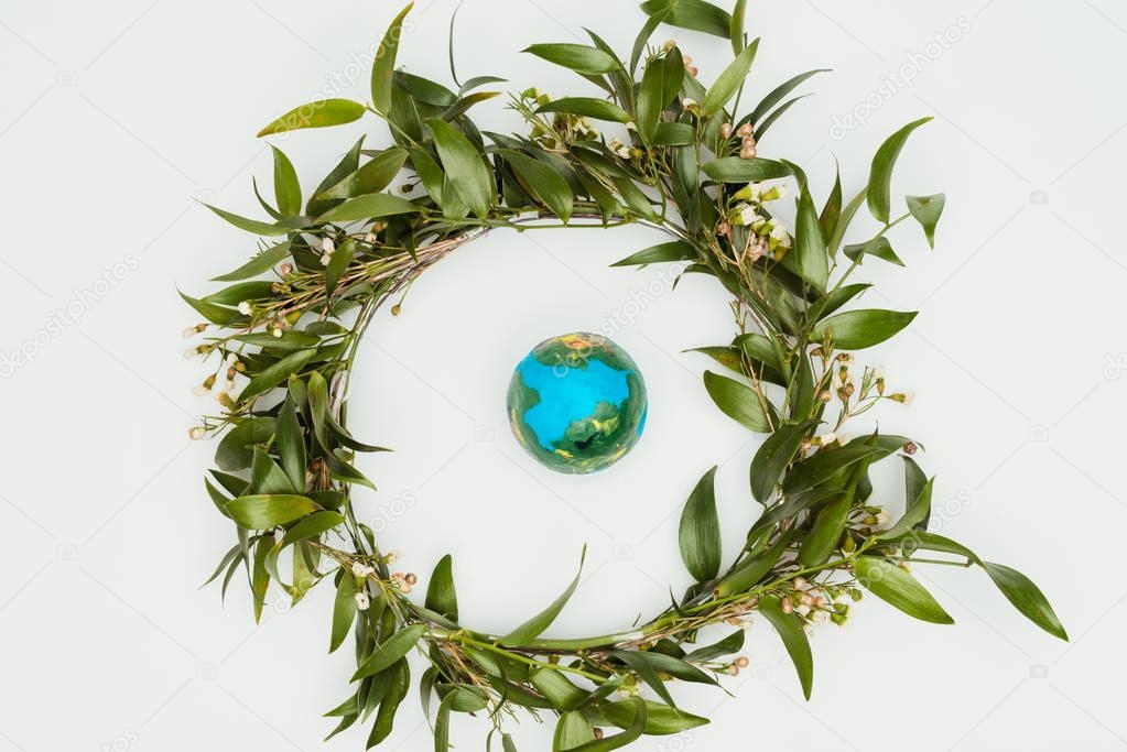 top view of leaves wreath with model earth isolated on white, earth day concept