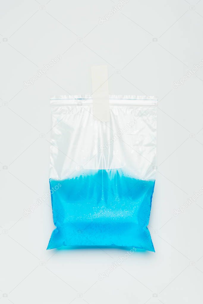 plastic bag with blue water hanging isolated on white, earth day concept