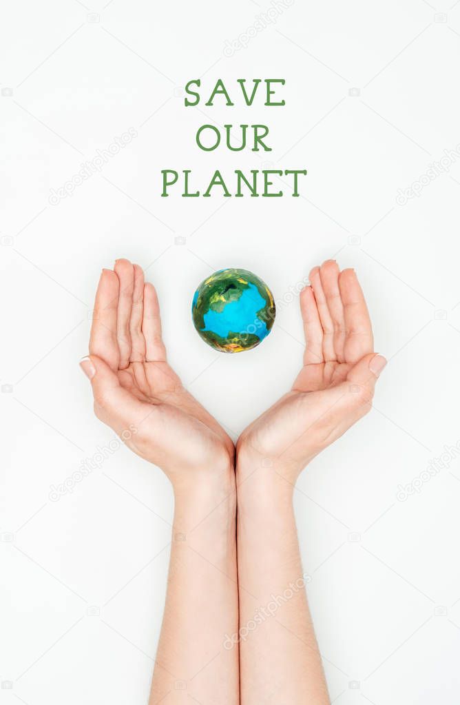 cropped image of woman holding earth model with sign save our planet isolated on white, earth day concept