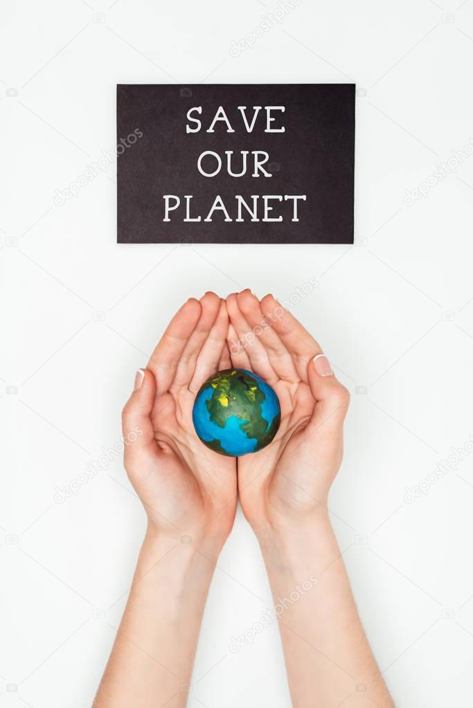 cropped image of woman holding earth model in hands under sign save our planet isolated on white, earth day concept