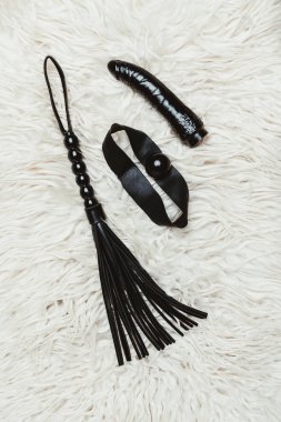 Black leather whip and ball gag with dildo clipart