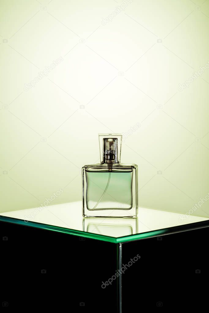 bottle of womans fragrance on glass table