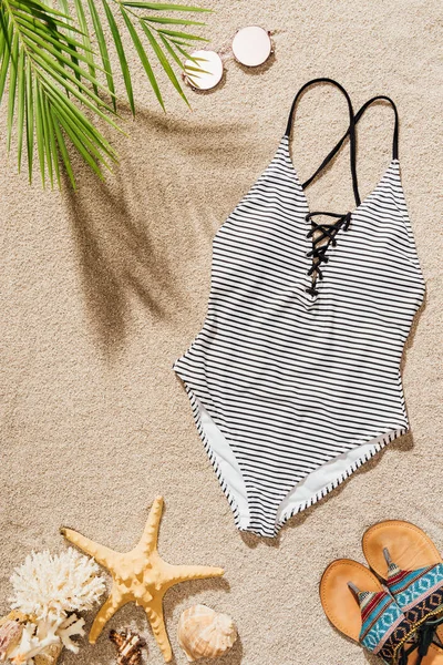 Top View Swimsuit Sunglasses Flip Flops Lying Sandy Beach — Stock Photo, Image