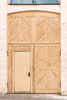 Wooden vintage doors in brick wall clipart