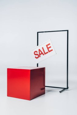 red cube, stand and sale sign, summer sale concept clipart