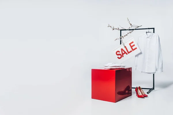 red cube, high heels and sale sign, summer sale concept