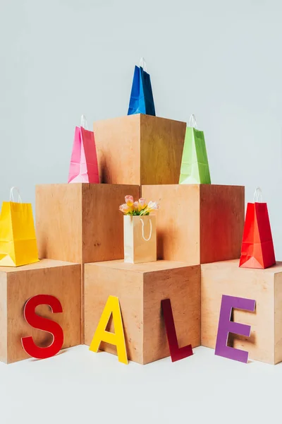 Colored Shopping Bags Wooden Stands Sale Sign Summer Sale Concept — Free Stock Photo