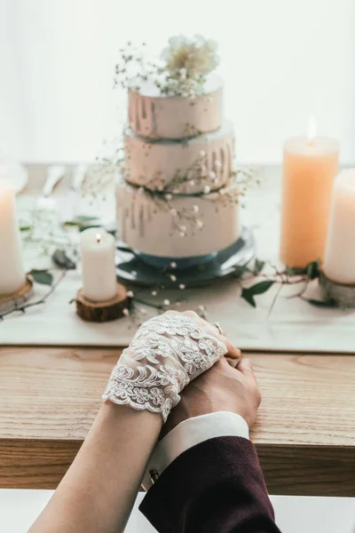 Partial View Newlyweds Holding Hands While Sitting Served Table Wedding — Stock Photo, Image