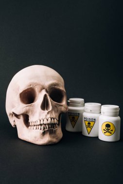 Scull and jars with poison sign isolated on black clipart