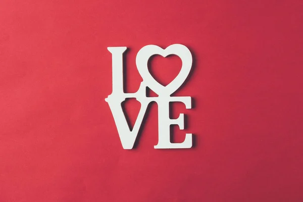 Top view of white sign with word love isolated on red — Stock Photo