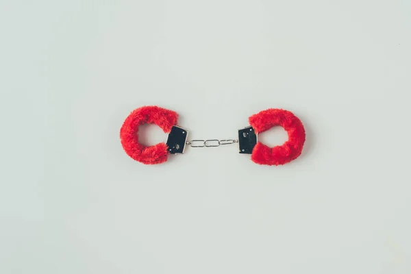 Top view of locked red fluffy handcuffs isolated on white, valentines day concept — Stock Photo