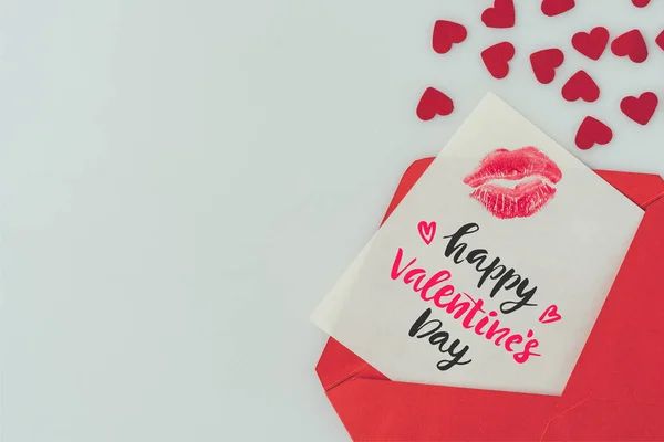 Top view of happy valentines day postcard with lips print in envelope isolated on white — Stock Photo